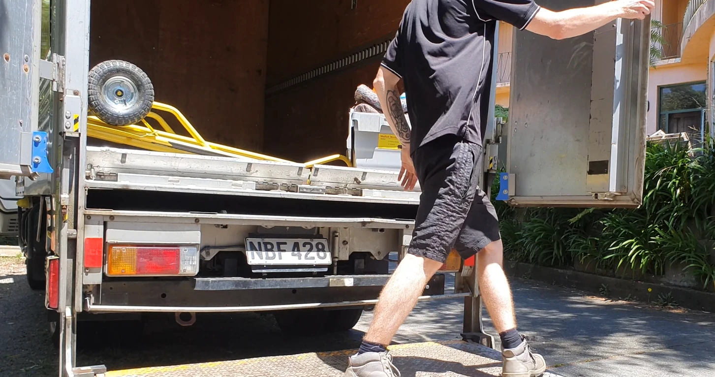 Opening the box truck rear doors to load the small moving truck