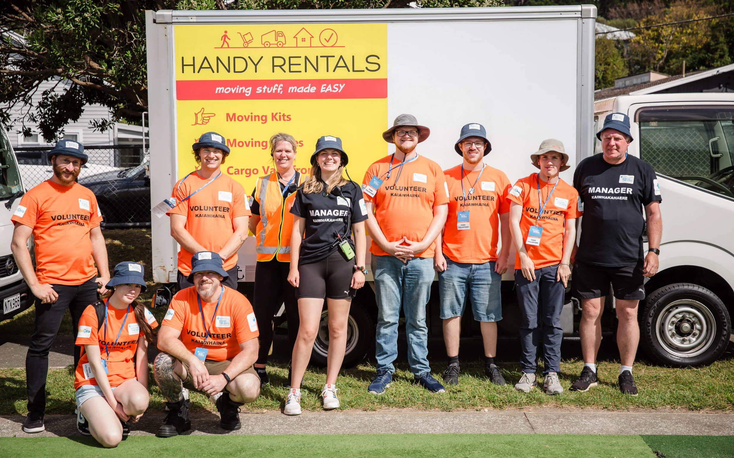 Organisers and volunteers standing with a Handy Rentals truck