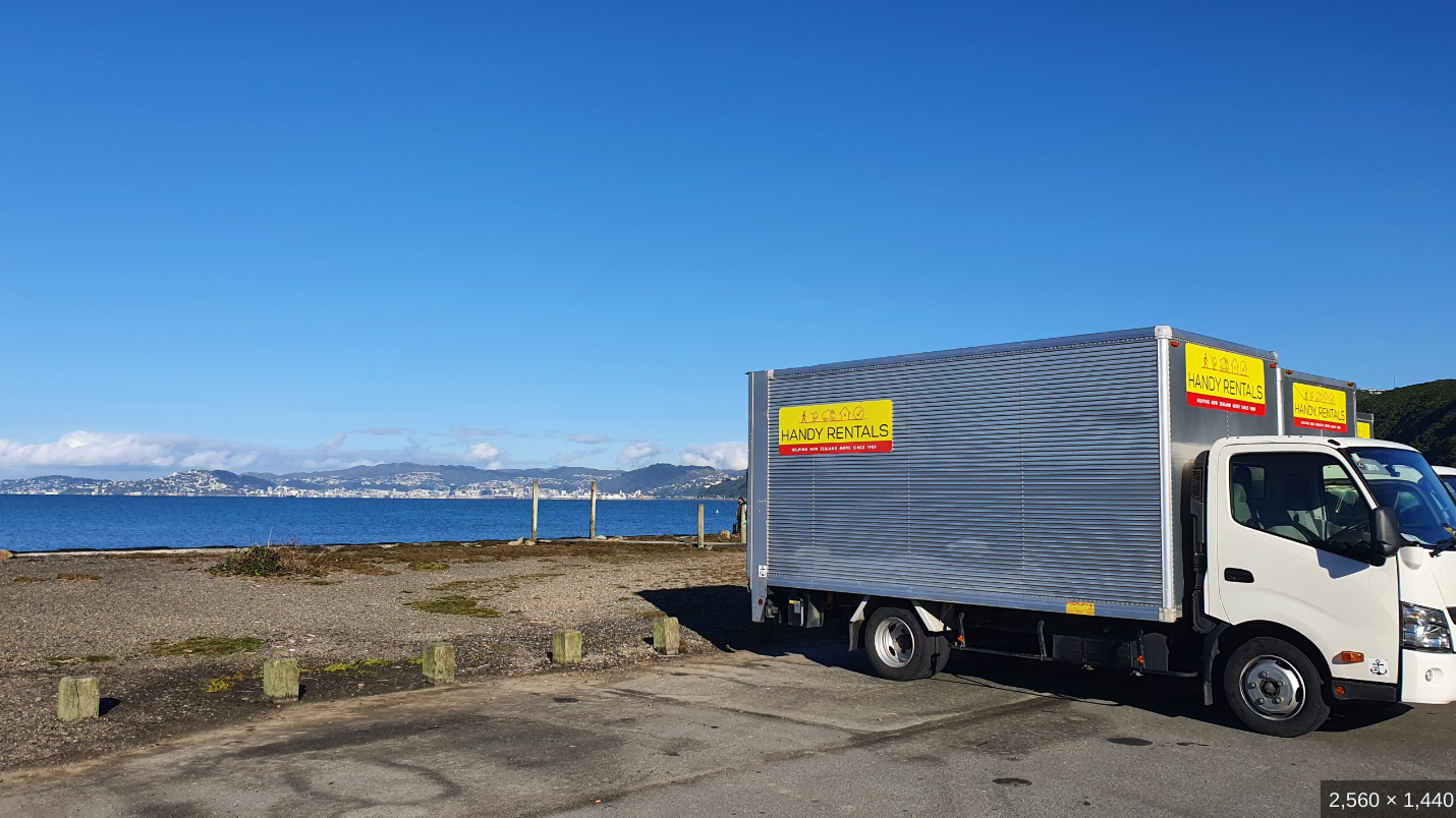 Rental trucks parked beside Wellington harbour