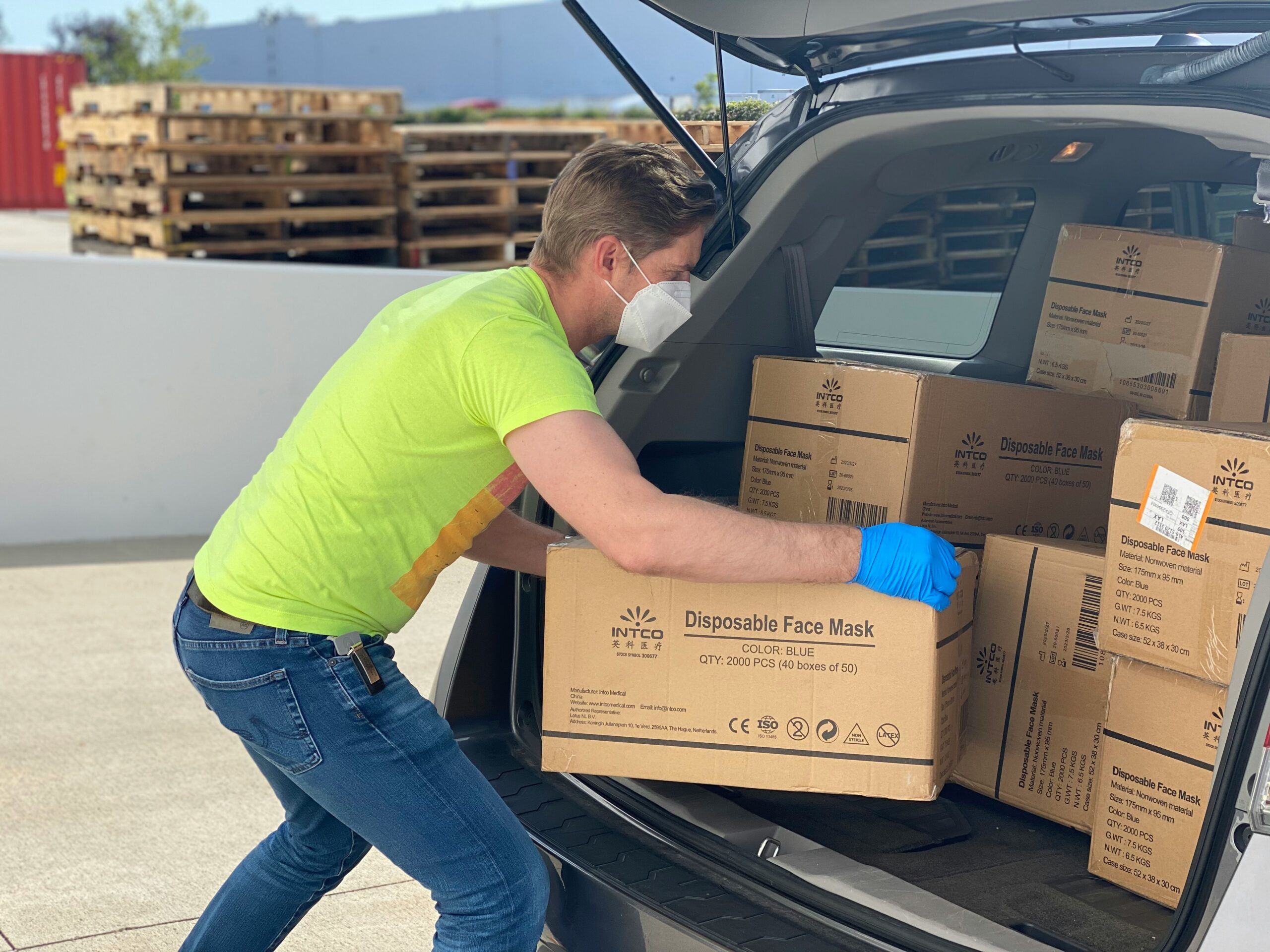 Man loading boxes into commercial vehicle for transportation