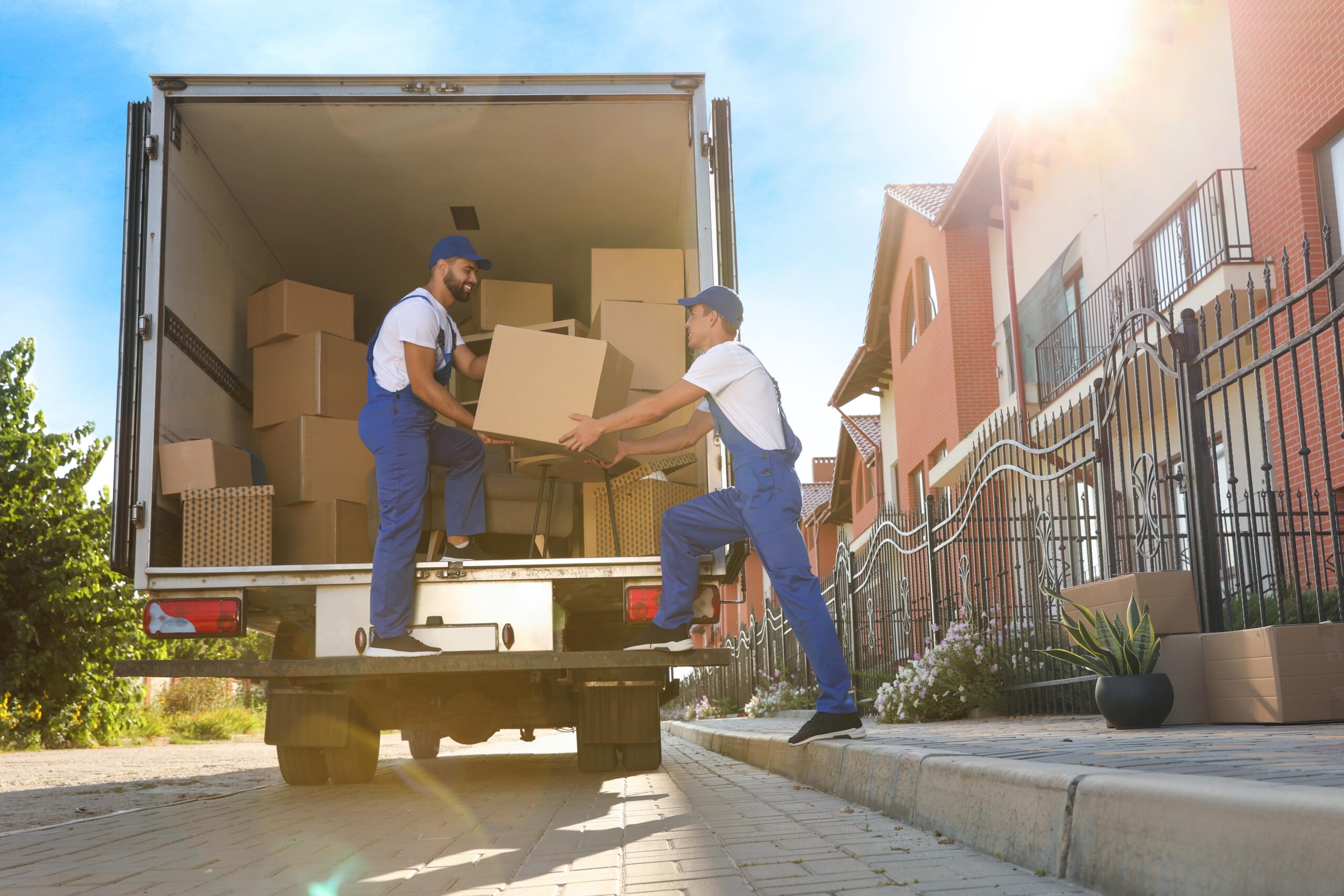 removal company movers, moving boxes from rear of a truck