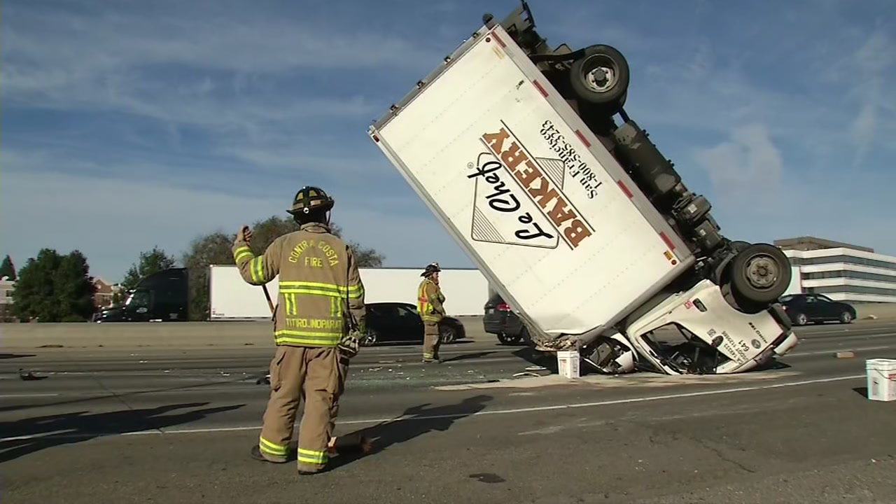 box truck with firefighter in front on its roof